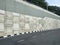 Precast concrete retaining wall panels are installed in layers as a retaining wall.