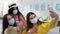 Precautions, young girls in medical masks taking selfie using a mobile phone during summer holidays