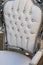 Precious ancient chair in white leather that looks like a thron