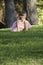 Precious ittle girl in pink dress on grass