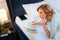 Precious light-haired woman resting in unfinished bed with hardcover book