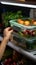 Precise moment Female hands grasp food container from fridge, close up perspective