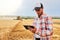 Precision farming. Farmer holding tablet for combine harvester guidance and control with modern automation system