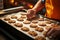 With precision, a seasoned chef carries a tray of oven fresh, steamy cookies