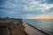 Predawn sky at the sea on a cloudy morning. Ships can be seen against the background of sunrise on the horizon. Dropping off the