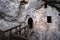 Predjama Castle in Slovenia. Interior of a castle hidden in a cave. Entrance to the fortification with a wooden bridge.