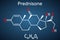 Prednisone molecule. A synthetic anti-inflammatory glucocorticoid derived from cortisone. Structural chemical formula on the dark