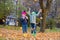 Preeten boy and girl jump in autumn leaves