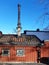 Prefab building roof with industrial black chimney under blue sky. Architecture and construction detail