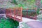 Prefabricated small steel bridge on hiking trail over dry creek in park