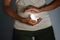 Pregnancy and abortion. A paper-cut silhouette of an embryo in a woman`s hands. Dark colors