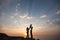 Pregnancy and happy family. The pregnant wife with her husband and child holding hands walking on the sea sunset.