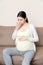 Pregnancy Morning Sickness. Pregnant Woman Having Nausea Feeling Bad in Sofa at the Home