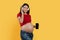 Pregnancy Music App. Cheerful Pregnant Woman In Wireless Headphones Showing Blank Smartphone
