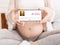 Pregnancy Music Playist. Pregnant woman holding cellphone with audio player app interface