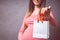 Pregnancy shopping, motherhood, people and expectation concept - pregnant woman with shopping bag touching her big belly