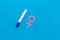 Pregnancy test with two strips and Venus sign - baby girl expectation - on blue background top-down