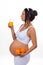Pregnancy and vitamins. Pregnant woman and oranges and fresh juice.