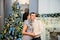 Pregnancy, winter holidays and people concept - happy pregnant wife with husband at home at christmas.