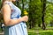 Pregnancy woman walk. Pregnant nature walk. Happy maternity mother in summer park. Baby belly. Pregnancy activity.