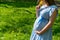 Pregnancy woman walk. Pregnant nature walk. Happy maternity mother in summer park. Baby belly. Pregnancy activity.