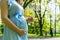 Pregnancy woman walk. Pregnant nature walk. Happy maternity mother in summer park. Baby belly. Pregnancy activity.