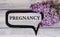 PREGNANCY - word on a light background with gentle lilac