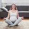 Pregnancy yoga. Beautiful expectant mother doing yoga at home. sitting in lotus Relaxation