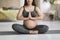Pregnancy Yoga. Cropped Shot Of Young Pregnant Woman Sitting In Lotus Position