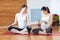 Pregnancy Yoga, Fitness concept. Two beautiful young pregnant yoga models working out indoor. Pregnant smiling fitness women sitti