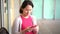 Pregnant Asian Chinese Mother using her smartphone to communicate worried