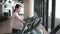 Pregnant Asian woman exercising in the gym indoors for a fit and active pregnancy