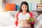 Pregnant asian woman holding salad bowl, give thump up with smile face. Vegetable is healthy food for pregnancy mother. Mom care