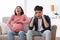 Pregnant Asian Woman Screaming Having Spasm Sitting With Husband Indoors