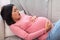 Pregnant Asian Woman Touching Belly Having Painful Contractions At Home