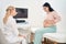 Pregnant asian woman visiting sonographer for extra ultrasound