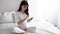 Pregnant Attractive Woman Using Mobile Phone At Bed