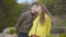 Pregnant beautiful woman posing with her son in the autumn park. Teenage boy kissing cheek of his young redhead