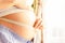 Pregnant belly woman measure. Happy beautiful pregnant woman with tape measuring belly. Pregnancy, medicine health care