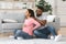 Pregnant black woman suffering from backache, husband massaging her shoulders