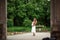 Pregnant brunette woman at an old building gazebo