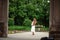 Pregnant brunette woman at an old building gazebo