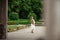 Pregnant brunette woman at an old building gazebo