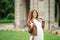 Pregnant brunette woman at an old building gazebo