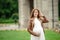 Pregnant brunette woman at an old building gazebo
