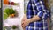 Pregnant Caucasian woman opens the refrigerator. Belly in anticipation of the baby close-up. Healthy eating of fruits