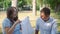 Pregnant Couple Looking at Baby Dress in Park