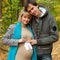 Pregnant couple posing with baby socks