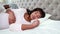 Pregnant couple sleeping in bed