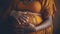 A pregnant dark-skinned woman holds her stomach with two hands. The concept of motherhood. Close-up of a pregnant